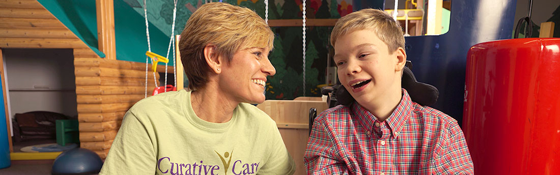 Adolescent boy smiling at female therapist