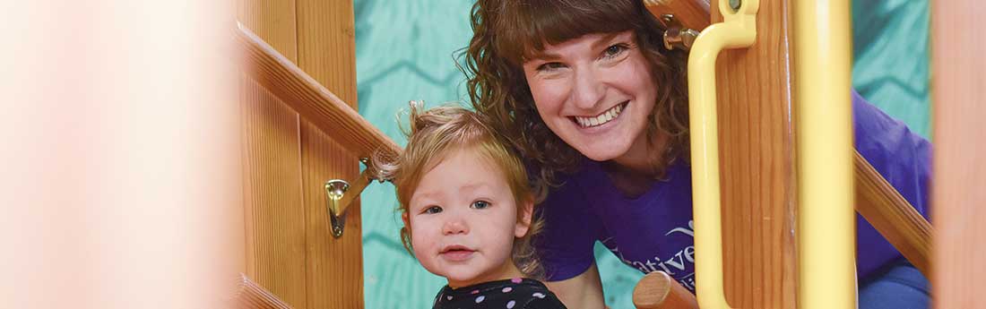 Young girl walking up stairs with female therapist