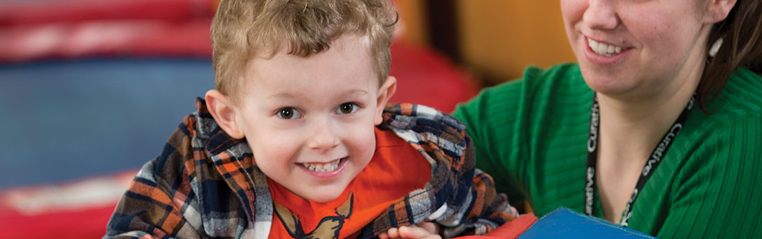 Young boy smiling during therapy