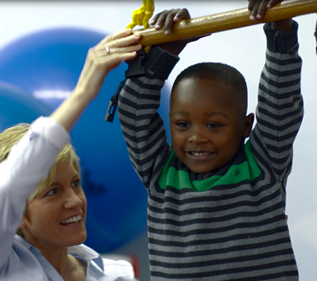 Jermaine using zip line with help of female therapist