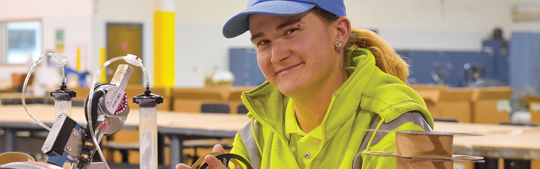 Female assembly worker in production warehouse