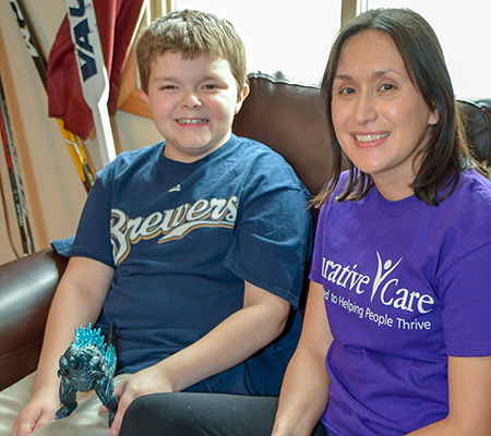 Nigel and female service coordinator sitting on couch