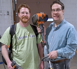 Patrick and male supervisor holding landscape equipment