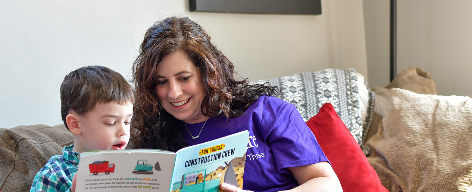 Young boy reading with therapist